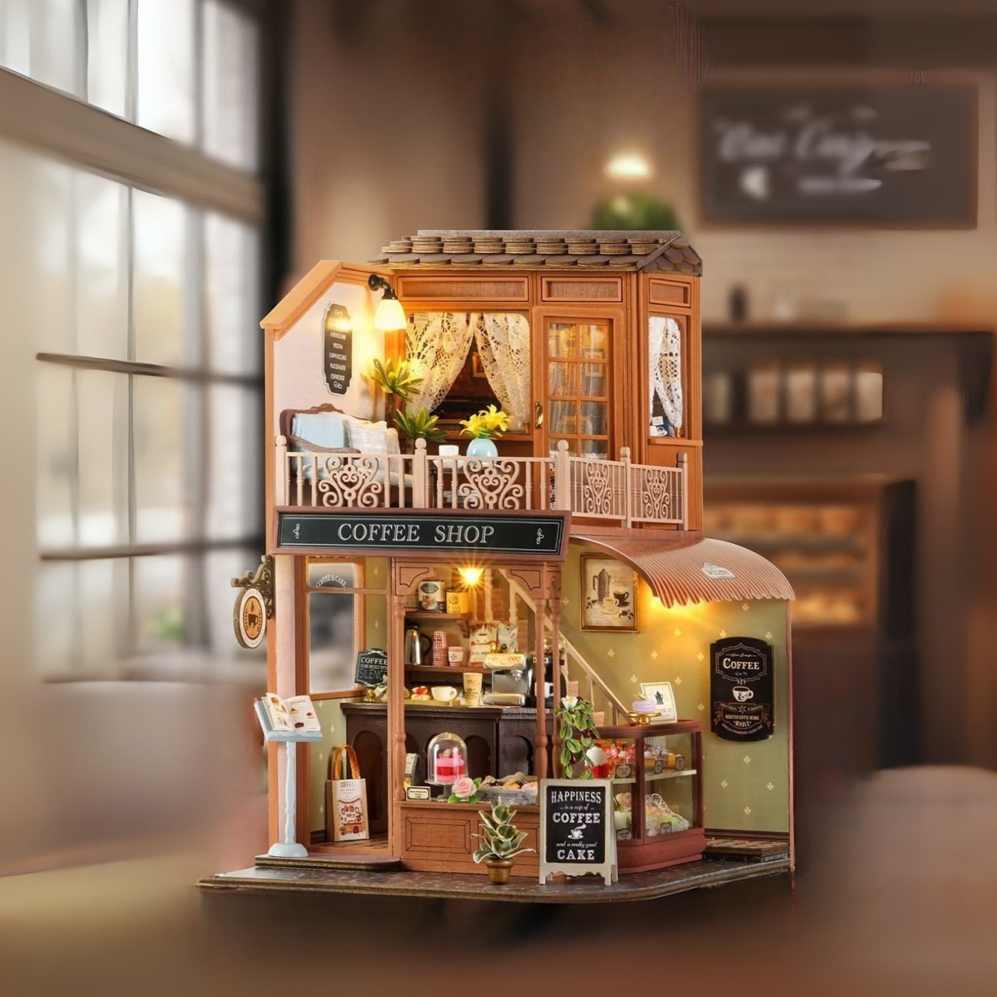 DIY mini house kit “Perch & Latte Loft,” featuring a cozy two-story coffee shop with a glowing café interior, reading nook, lace-curtained loft, and tiny desserts. A warm and detailed build for DIY and crafts lovers and fans of miniature homes.