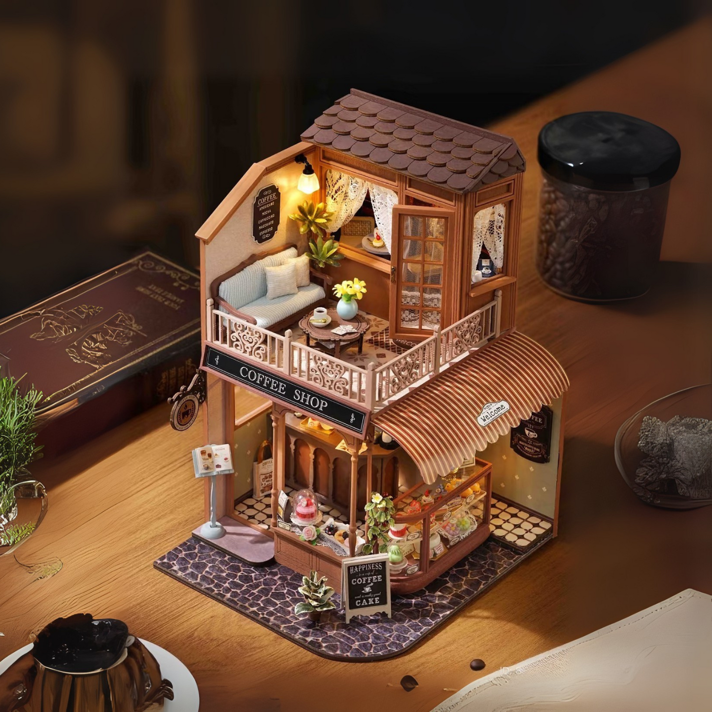 DIY mini house kit “Perch & Latte Loft,” featuring a cozy two-story coffee shop with a glowing café interior, reading nook, lace-curtained loft, and tiny desserts. A warm and detailed build for DIY and crafts lovers and fans of miniature homes.