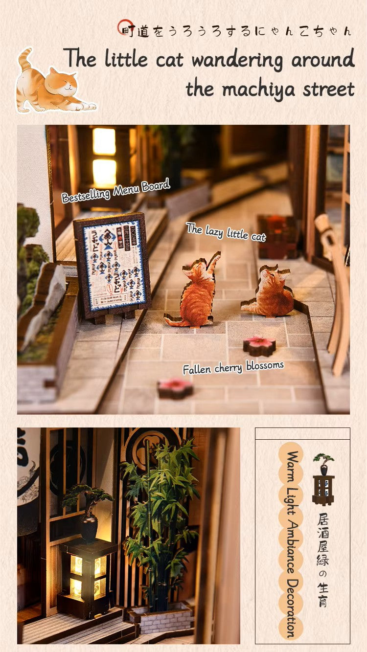 DIY book nook kit “Neko Alley Nook,” featuring a Japanese alleyway with miniature shopfronts, paper lanterns, wooden signage, and lounging cats. A charming DIY and crafts project for Japan enthusiasts and book nook collectors.