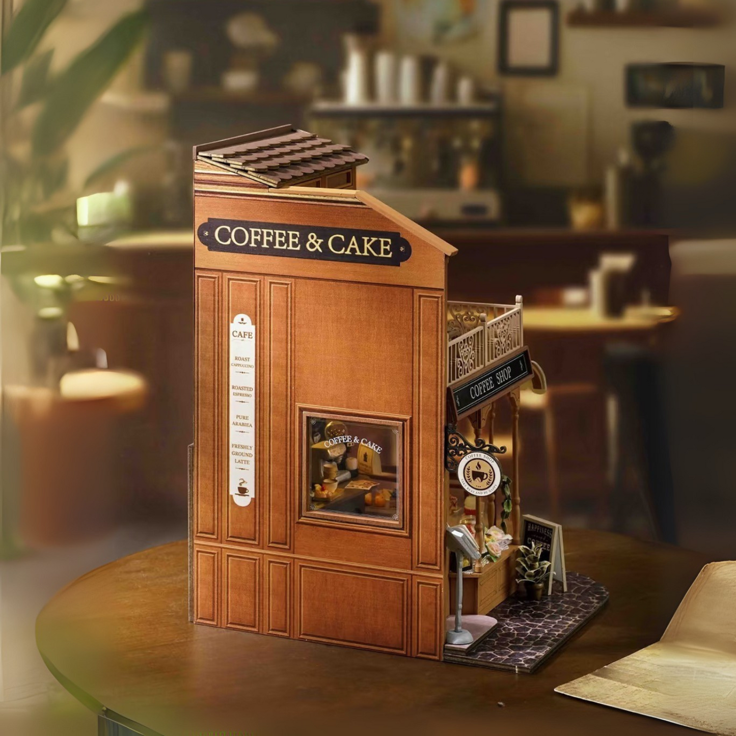 DIY mini house kit “Perch & Latte Loft,” featuring a cozy two-story coffee shop with a glowing café interior, reading nook, lace-curtained loft, and tiny desserts. A warm and detailed build for DIY and crafts lovers and fans of miniature homes.