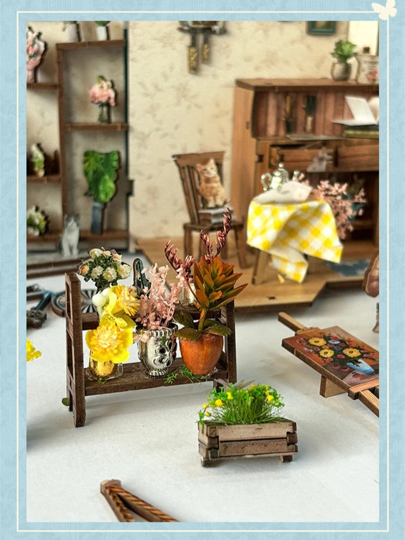 DIY book nook kit “Springkeeper’s Shop” featuring a cheerful miniature flower store with potted plants, blooming flowers, a striped awning, and a small cat. A charming craft idea for DIY and crafts lovers, perfect for fans of miniatures and DIY tiny home kits.