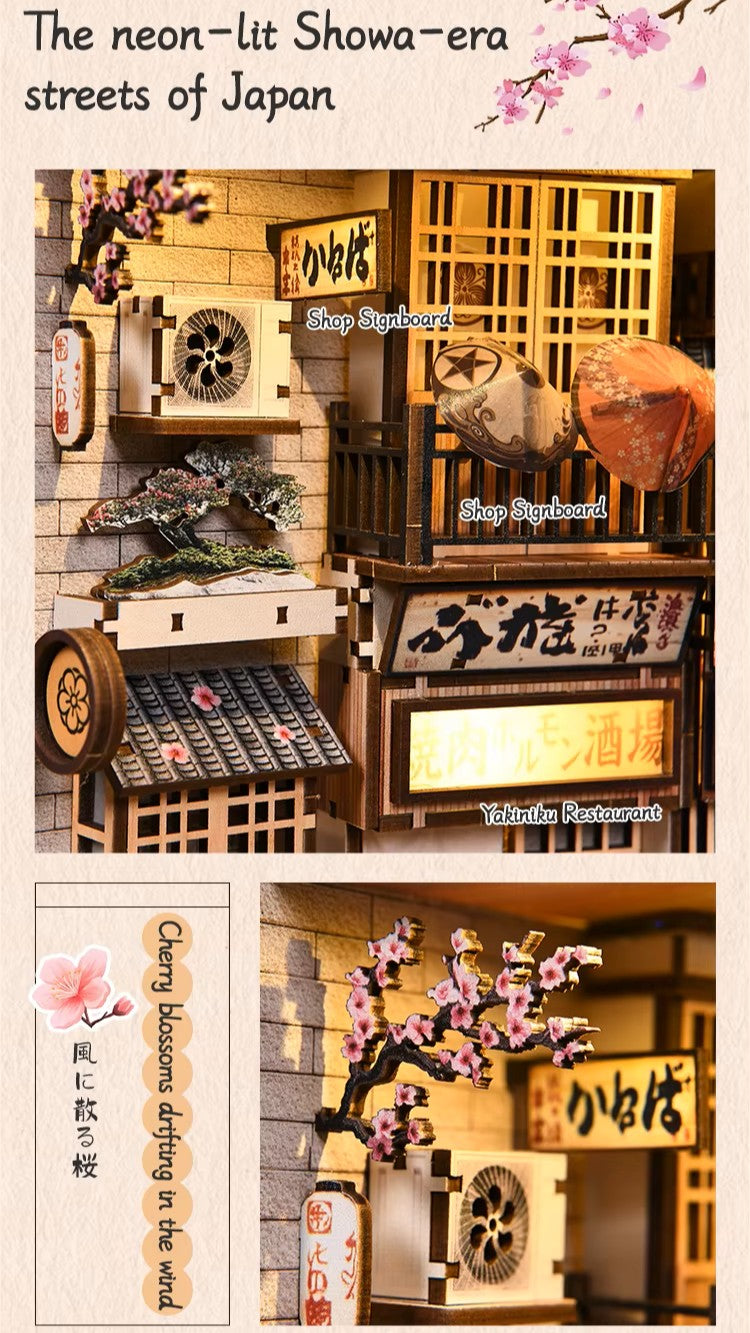 DIY book nook kit “Neko Alley Nook,” featuring a Japanese alleyway with miniature shopfronts, paper lanterns, wooden signage, and lounging cats. A charming DIY and crafts project for Japan enthusiasts and book nook collectors.
