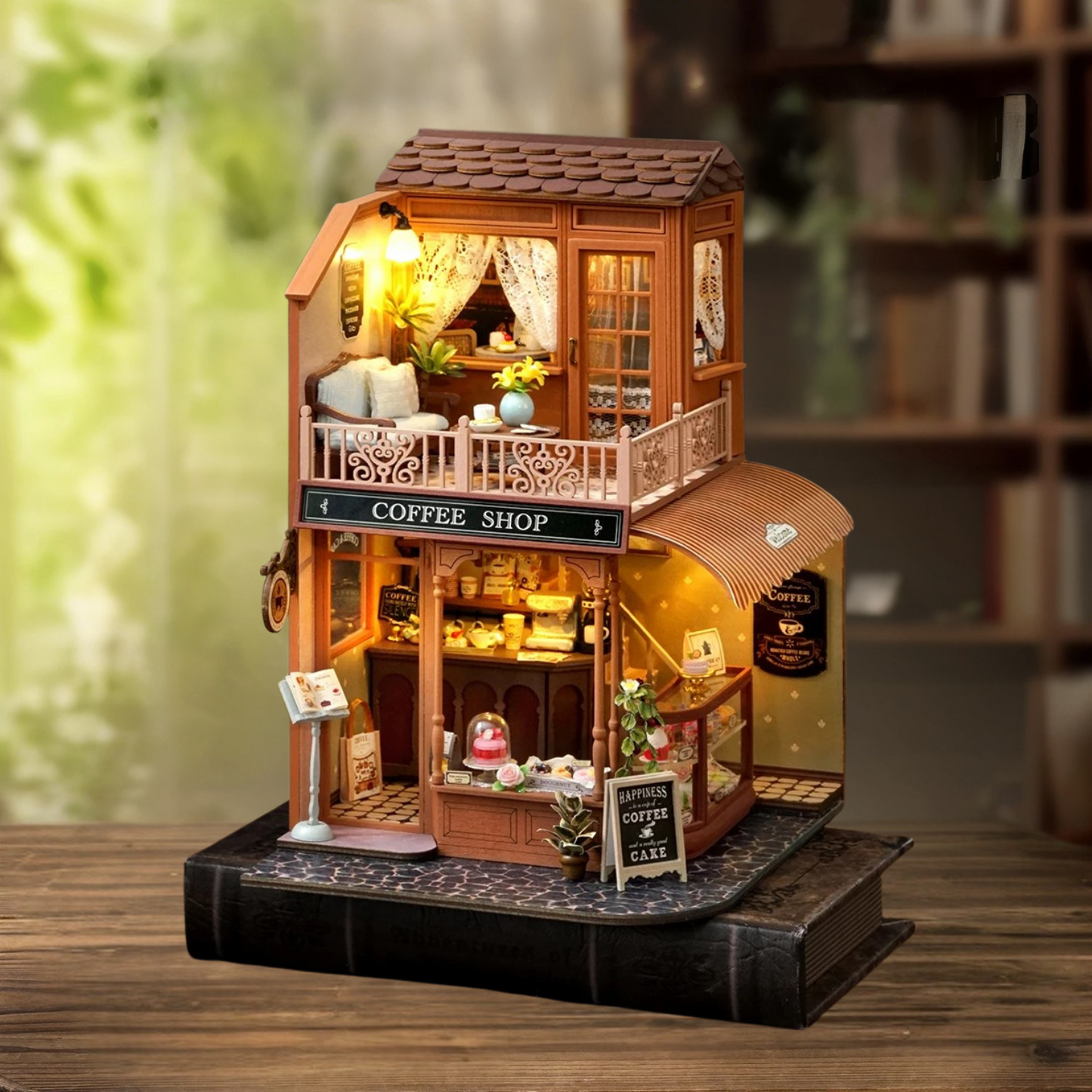 DIY mini house kit “Perch & Latte Loft,” featuring a cozy two-story coffee shop with a glowing café interior, reading nook, lace-curtained loft, and tiny desserts. A warm and detailed build for DIY and crafts lovers and fans of miniature homes.