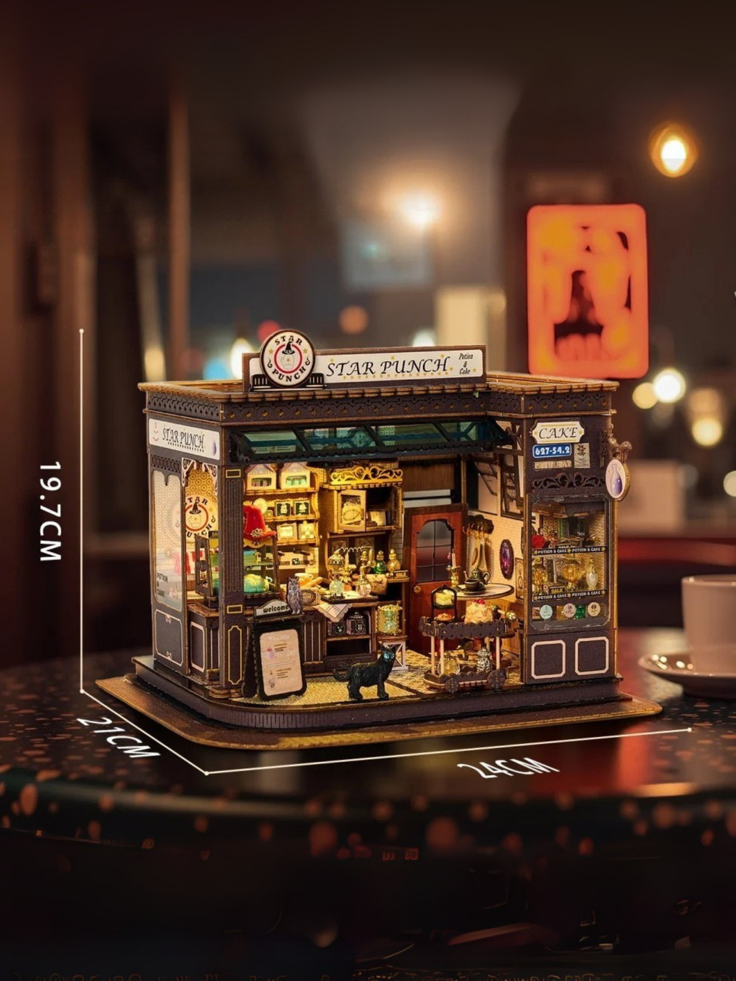 DIY miniature kit featuring “Potion Patisserie,” a whimsical cake and potion shop. Includes magical decor, sweets, golden teapots, and a black cat. Ideal for DIY and crafts lovers, fantasy collectors, and tiny dollhouse hobbyists.
