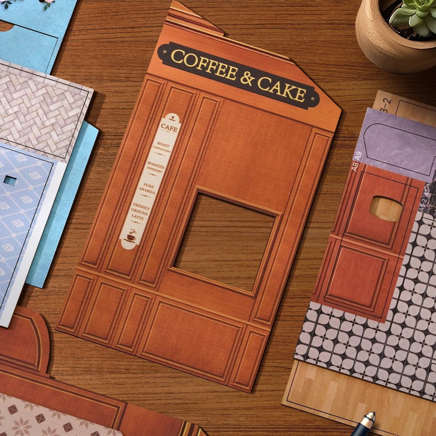 DIY mini house kit “Perch & Latte Loft,” featuring a cozy two-story coffee shop with a glowing café interior, reading nook, lace-curtained loft, and tiny desserts. A warm and detailed build for DIY and crafts lovers and fans of miniature homes.