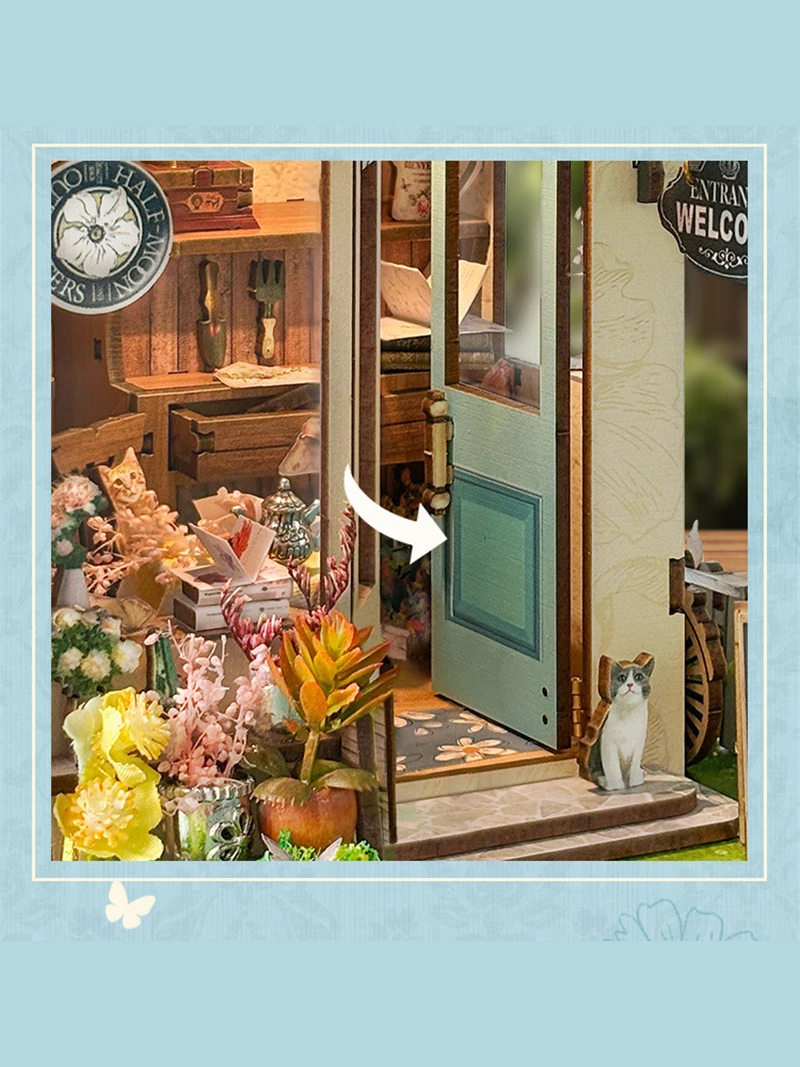 DIY book nook kit “Springkeeper’s Shop” featuring a cheerful miniature flower store with potted plants, blooming flowers, a striped awning, and a small cat. A charming craft idea for DIY and crafts lovers, perfect for fans of miniatures and DIY tiny home kits.