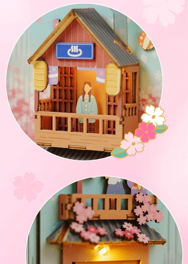 DIY book nook kit “Sakura Market,” featuring a glowing cherry blossom-lined miniature street scene with lanterns, shops, umbrellas, and Japanese architecture. Ideal for DIY and crafts lovers and fans of tiny dollhouses and book nook displays.