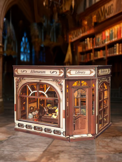 DIY miniature house kit styled as an Athenaeum library with classical columns, bookshelves, and warm lighting in an old-world study.