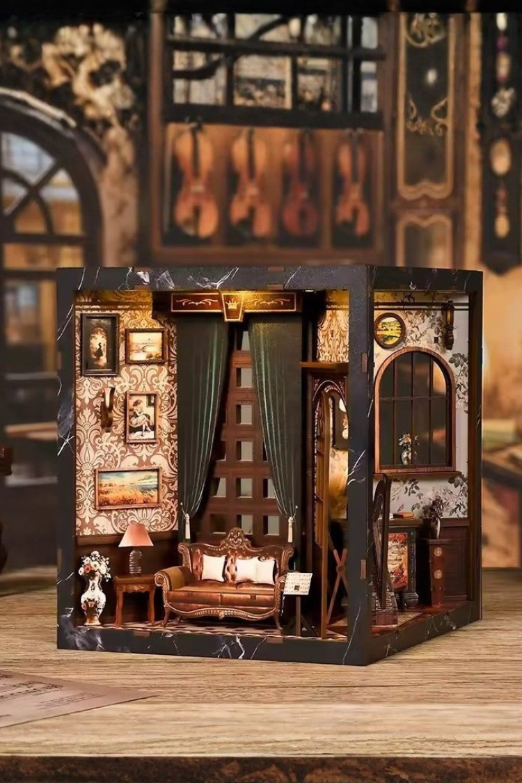 DIY miniature house with four connected scenes: a Victorian-style lounge, a hallway with a harp and bell, a floral piano practice room, and a richly decorated violin performance stage—each side forming a corner of a cube-shaped music-themed diorama.