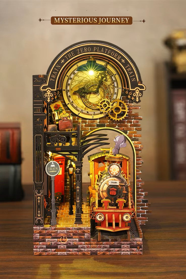 DIY book nook kit “Platform Arcane,” featuring a mechanical fantasy train station with glowing lights, gears, arched glass roof, red locomotive, and magical details. Ideal for DIY and crafts lovers, fantasy readers, and miniature train enthusiasts.