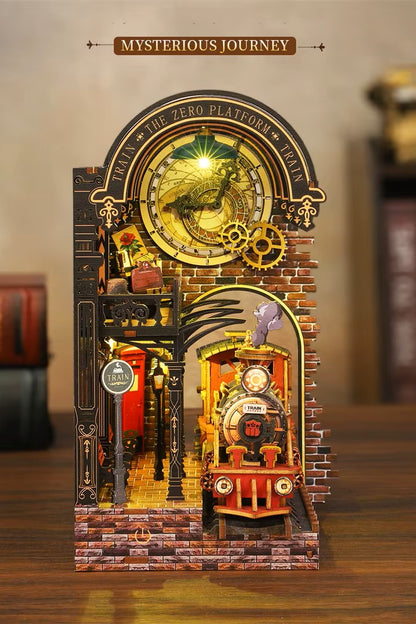 DIY book nook kit “Platform Arcane,” featuring a mechanical fantasy train station with glowing lights, gears, arched glass roof, red locomotive, and magical details. Ideal for DIY and crafts lovers, fantasy readers, and miniature train enthusiasts.