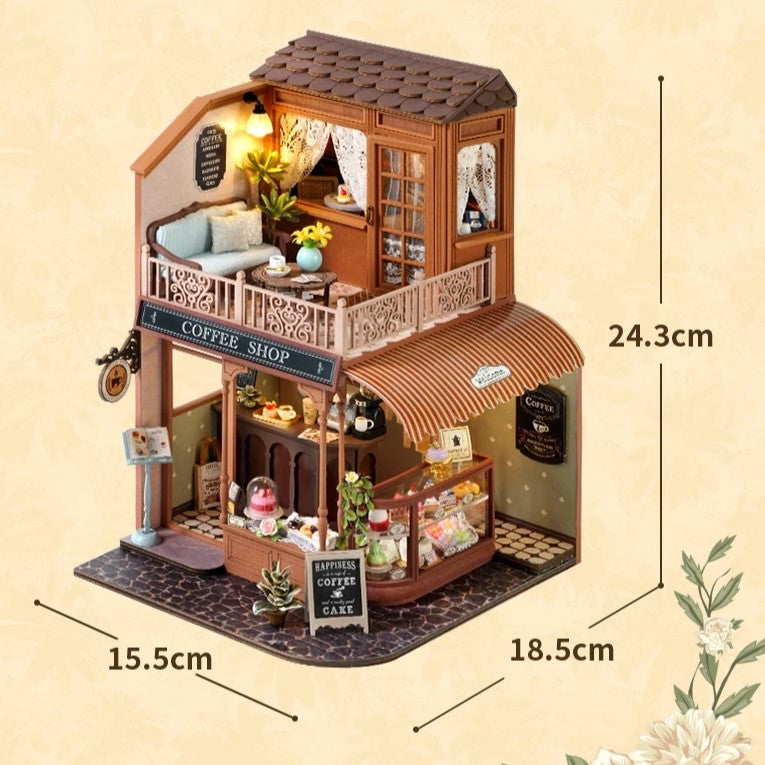 DIY mini house kit “Perch & Latte Loft,” featuring a cozy two-story coffee shop with a glowing café interior, reading nook, lace-curtained loft, and tiny desserts. A warm and detailed build for DIY and crafts lovers and fans of miniature homes.