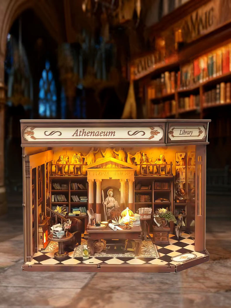 DIY miniature house kit styled as an Athenaeum library with classical columns, bookshelves, and warm lighting in an old-world study.