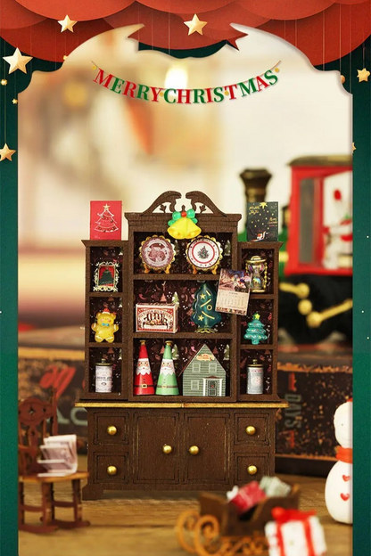 DIY miniature Christmas shop called “Jolly & Pine Christmas Shoppe,” featuring snow-dusted rooftops, holiday lights, a sleigh, Christmas tree, and cozy window displays. Ideal for holiday crafts, DIY mini home kits, and miniature house collectors.