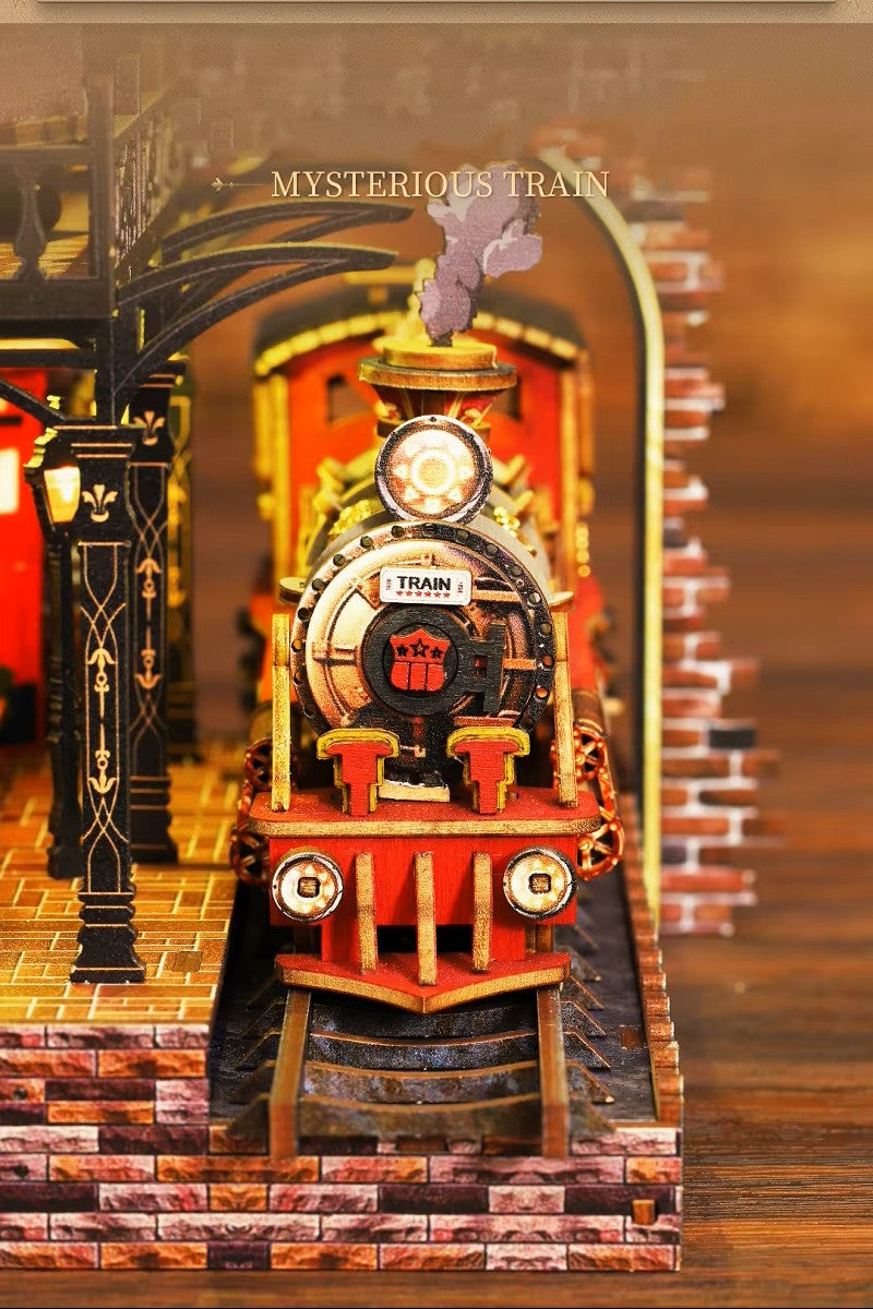 DIY book nook kit “Platform Arcane,” featuring a mechanical fantasy train station with glowing lights, gears, arched glass roof, red locomotive, and magical details. Ideal for DIY and crafts lovers, fantasy readers, and miniature train enthusiasts.