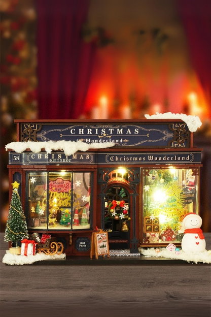 DIY miniature Christmas shop called “Jolly & Pine Christmas Shoppe,” featuring snow-dusted rooftops, holiday lights, a sleigh, Christmas tree, and cozy window displays. Ideal for holiday crafts, DIY mini home kits, and miniature house collectors.