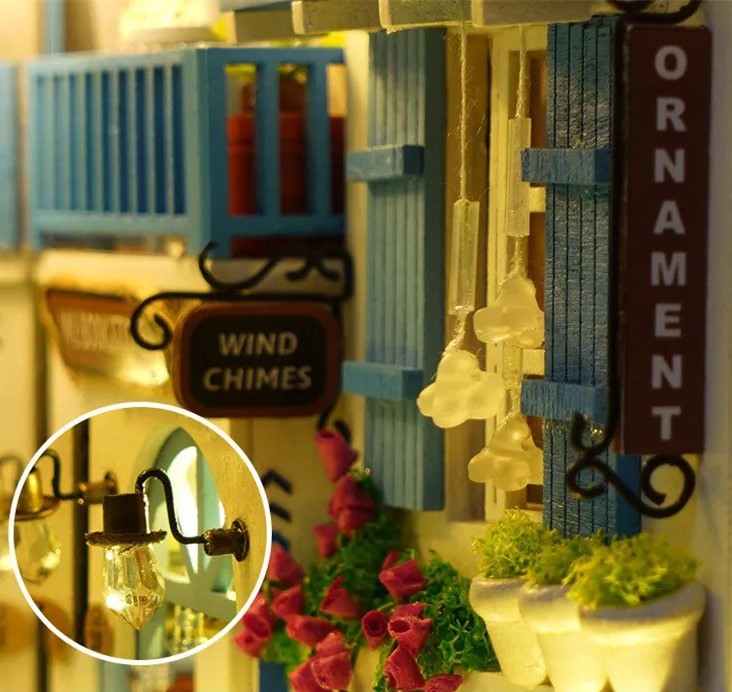 DIY and crafts lovers will enjoy this miniature book nook kit — a charming Mediterranean street scene that doubles as a bookshelf insert or home decor; perfect for craft ideas and making miniatures.