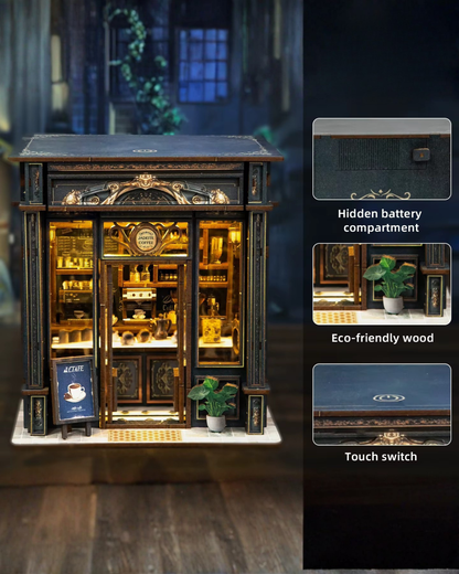 Miniature DIY book nook of a dark vintage-style café with glowing warm lights, ornate black storefront, and a coffee sign that reads “Jadeite Coffee.”