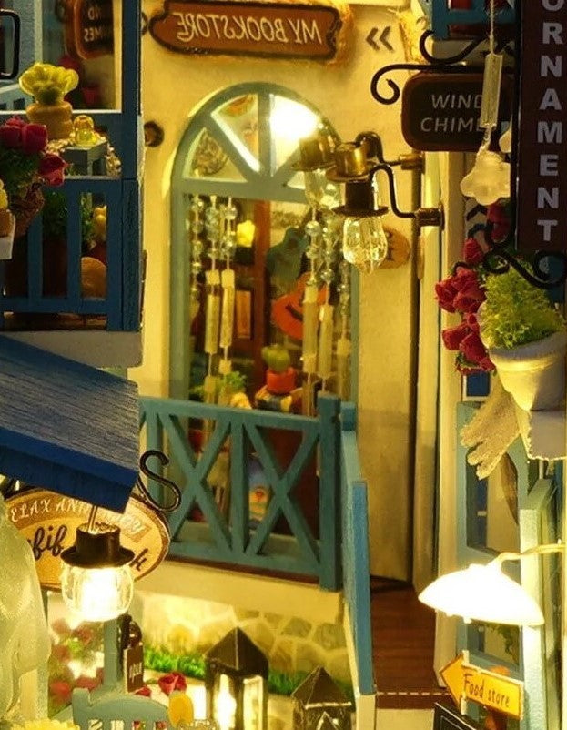 DIY and crafts lovers will enjoy this miniature book nook kit — a charming Mediterranean street scene that doubles as a bookshelf insert or home decor; perfect for craft ideas and making miniatures.