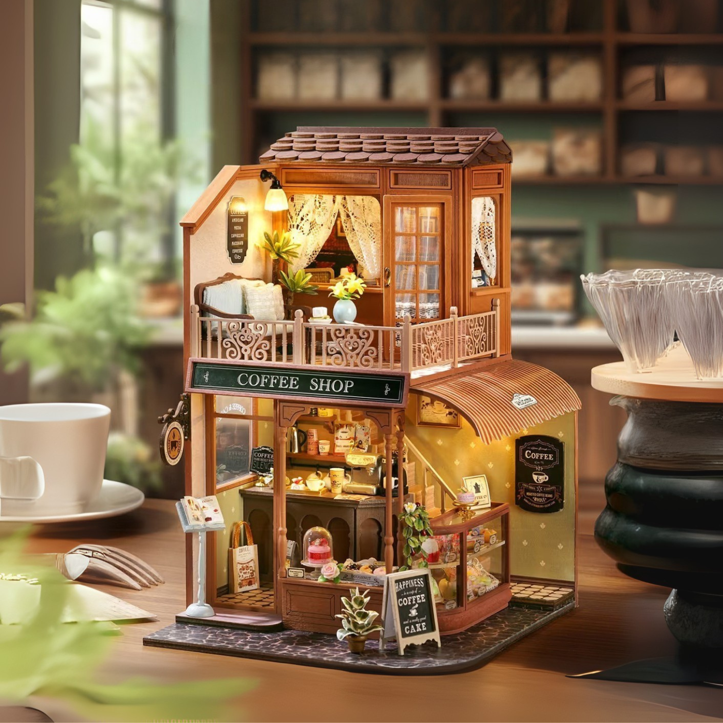 DIY mini house kit “Perch & Latte Loft,” featuring a cozy two-story coffee shop with a glowing café interior, reading nook, lace-curtained loft, and tiny desserts. A warm and detailed build for DIY and crafts lovers and fans of miniature homes.