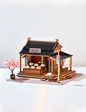 DIY mini house kit “Little Bao Shop,” featuring a traditional Chinese dumpling stand with miniature steamed buns, wooden tables, hanging signs, and a cherry blossom tree—perfect for DIY food miniatures and cultural craft ideas.