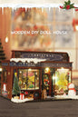 DIY miniature Christmas shop called “Jolly & Pine Christmas Shoppe,” featuring snow-dusted rooftops, holiday lights, a sleigh, Christmas tree, and cozy window displays. Ideal for holiday crafts, DIY mini home kits, and miniature house collectors.