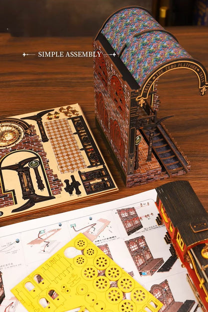DIY book nook kit “Platform Arcane,” featuring a mechanical fantasy train station with glowing lights, gears, arched glass roof, red locomotive, and magical details. Ideal for DIY and crafts lovers, fantasy readers, and miniature train enthusiasts.