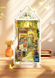 DIY garden book nook kit featuring a miniature outdoor café, greenery, tiny table setup, and rustic path — perfect for miniature lovers, DIY crafts, book nook fans, and small DIY house decor.