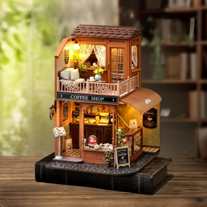 DIY mini house kit “Perch & Latte Loft,” featuring a cozy two-story coffee shop with a glowing café interior, reading nook, lace-curtained loft, and tiny desserts. A warm and detailed build for DIY and crafts lovers and fans of miniature homes.