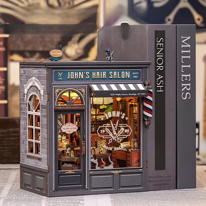 DIY book nook kit “Pomade Parlor,” featuring a vintage barbershop and hair salon interior with red chairs, mirrors, wooden shelves, and miniature grooming tools. A nostalgic DIY and crafts project for fans of retro style, miniatures, and classic salon design.