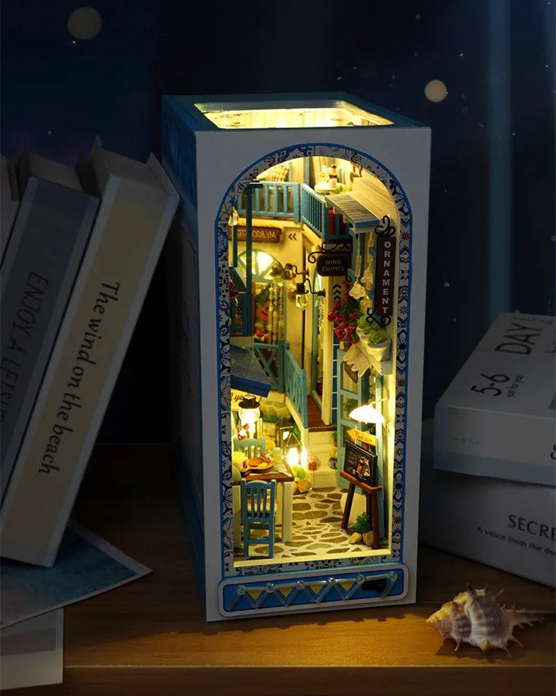 DIY and crafts lovers will enjoy this miniature book nook kit — a charming Mediterranean street scene that doubles as a bookshelf insert or home decor; perfect for craft ideas and making miniatures.