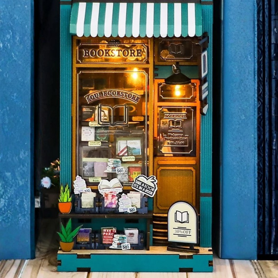 DIY book nook kit featuring a miniature bookstore with tiny books, shelves, cozy lighting, and vintage details — ideal for fans of miniatures, DIY crafts, scale models, and small DIY houses.