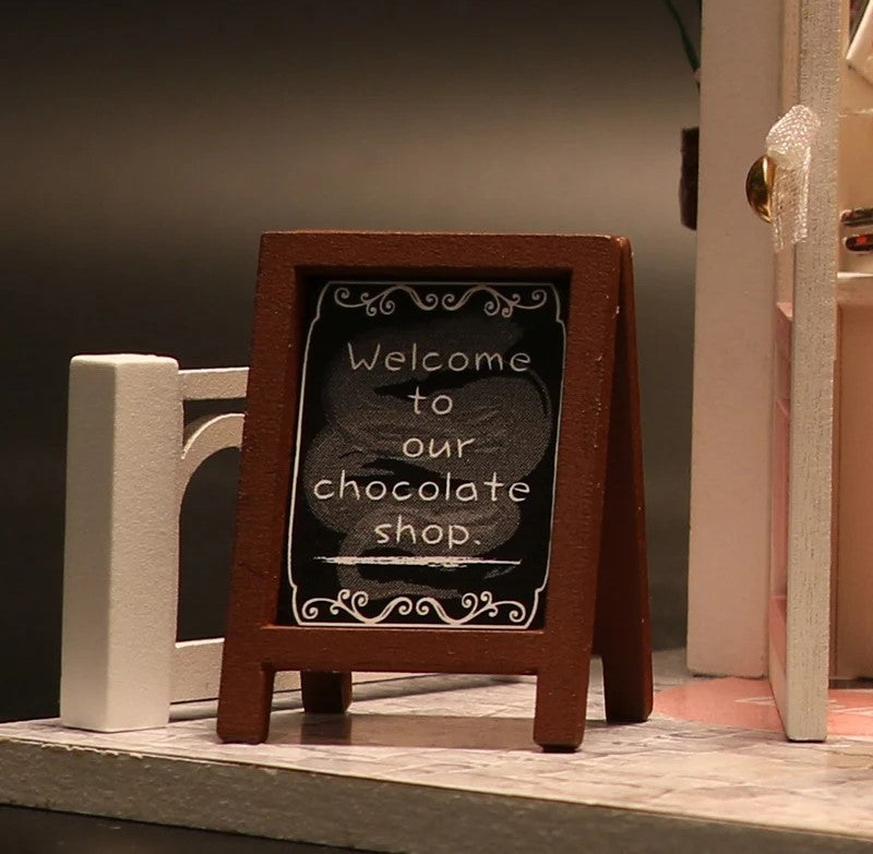 DIY miniature chocolate shop kit – a tiny dollhouse-style chocolatier with LED lights, perfect for book nook lovers, miniature mansion collectors, and fans of DIY crafts, miniatures, and small DIY houses.