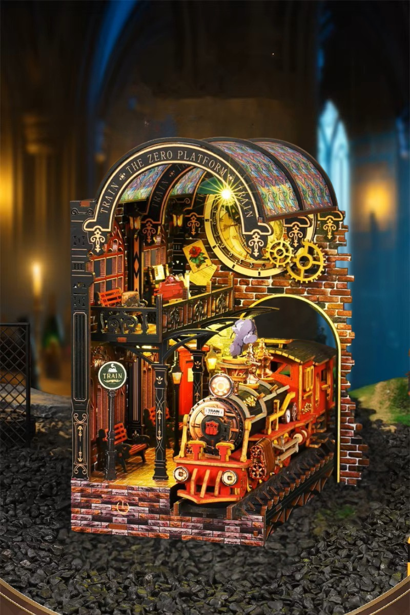 DIY book nook kit “Platform Arcane,” featuring a mechanical fantasy train station with glowing lights, gears, arched glass roof, red locomotive, and magical details. Ideal for DIY and crafts lovers, fantasy readers, and miniature train enthusiasts.