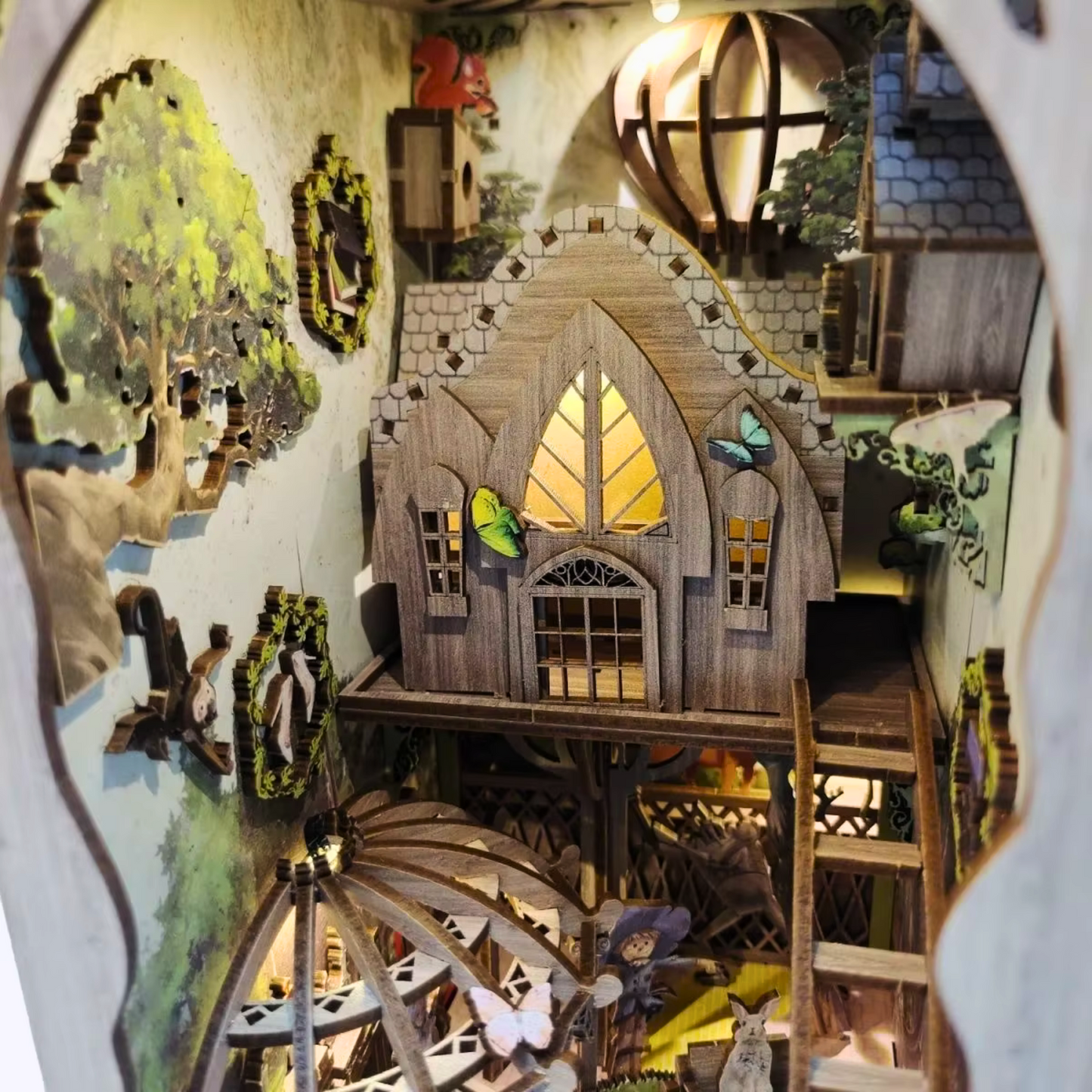 DIY book nook kit “Woodland Tales,” inspired by The Wizard of Oz. Features a glowing forest path with Dorothy and whimsical forest details. A magical DIY craft project for fans of storybook miniatures and fantasy-themed book nooks.