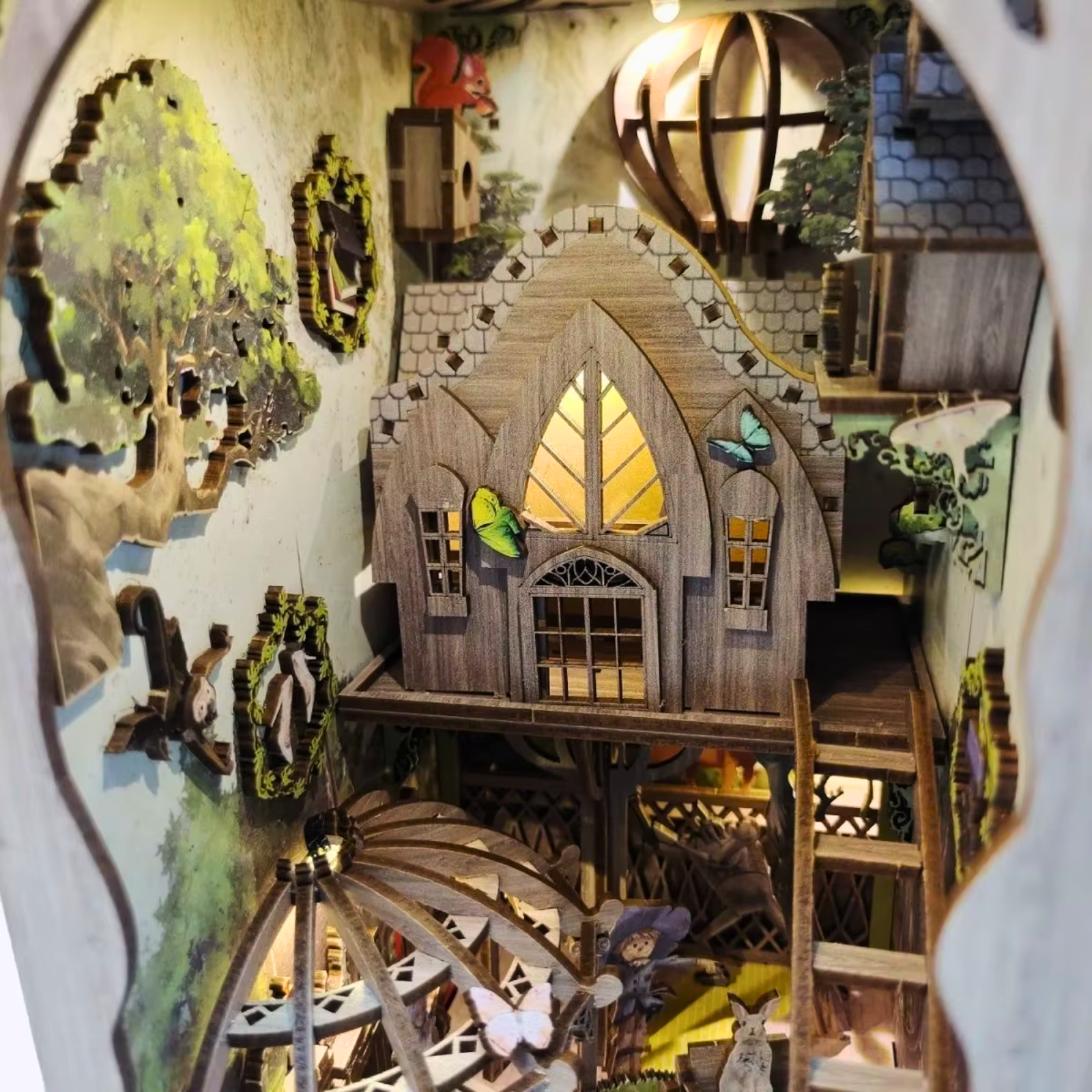 DIY book nook kit “Woodland Tales,” inspired by The Wizard of Oz. Features a glowing forest path with Dorothy and whimsical forest details. A magical DIY craft project for fans of storybook miniatures and fantasy-themed book nooks.