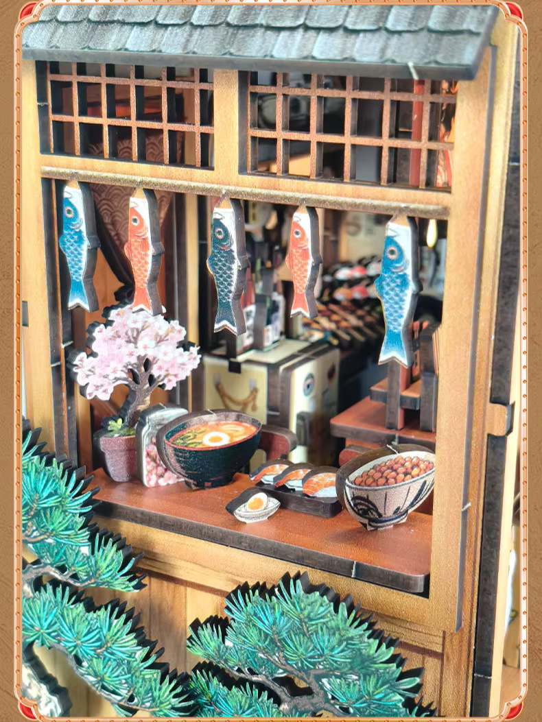 DIY miniature Japanese izakaya house featuring a cat chef, cherry blossom trees, hanging lanterns, a friendly Shiba Inu dog, and a warm glowing interior with tiny food items and sake bottles.