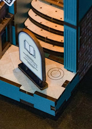 DIY book nook kit featuring a miniature bookstore with tiny books, shelves, cozy lighting, and vintage details — ideal for fans of miniatures, DIY crafts, scale models, and small DIY houses.
