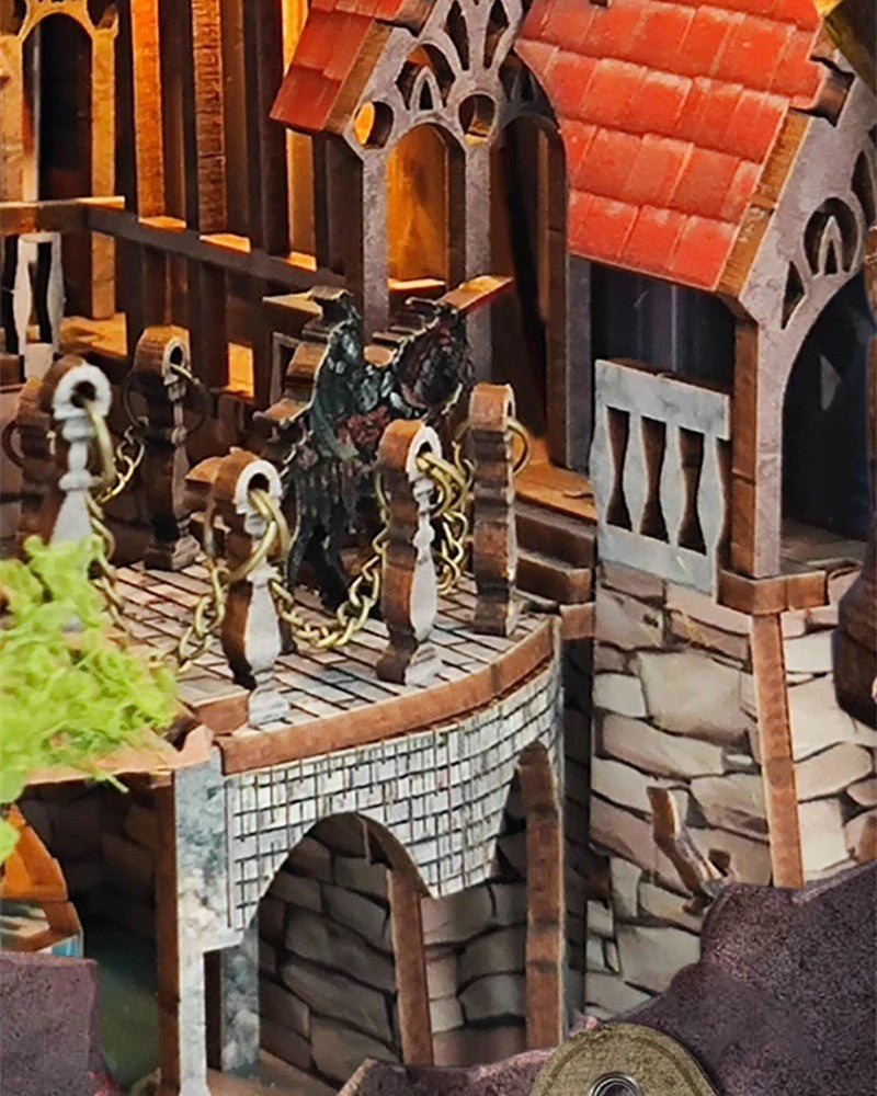 DIY fantasy book nook kit featuring a dragon-themed miniature valley with stone bridges, rooftops, and glowing landscape — ideal for miniature fans, DIY crafts, and book nook collectors.