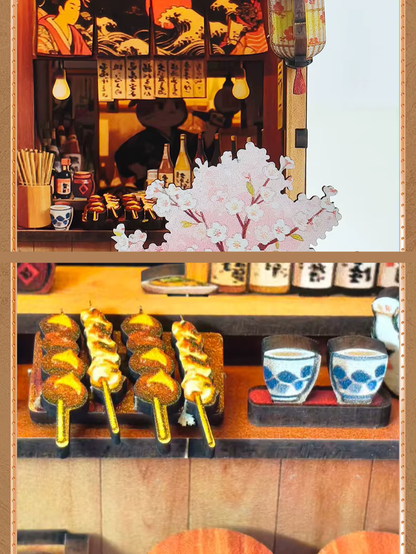 DIY miniature Japanese izakaya house featuring a cat chef, cherry blossom trees, hanging lanterns, a friendly Shiba Inu dog, and a warm glowing interior with tiny food items and sake bottles.
