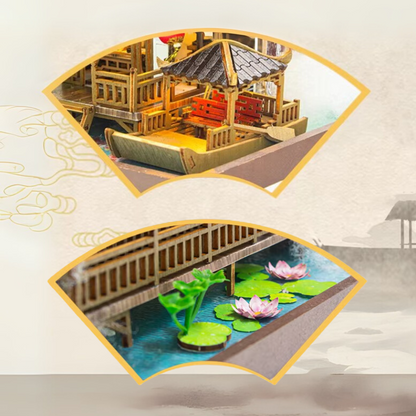 DIY miniature kit “Blossom Lantern Pavilion,” featuring a traditional East Asian-style building with curved roofs, cherry blossom trees, red lanterns, a waterfall, and glowing lights. A serene DIY and crafts project for fans of miniature homes and nature-inspired design.