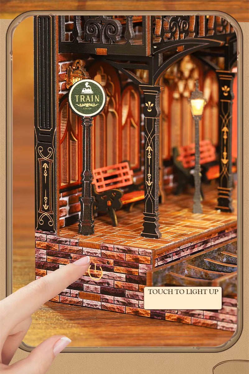 DIY book nook kit “Platform Arcane,” featuring a mechanical fantasy train station with glowing lights, gears, arched glass roof, red locomotive, and magical details. Ideal for DIY and crafts lovers, fantasy readers, and miniature train enthusiasts.