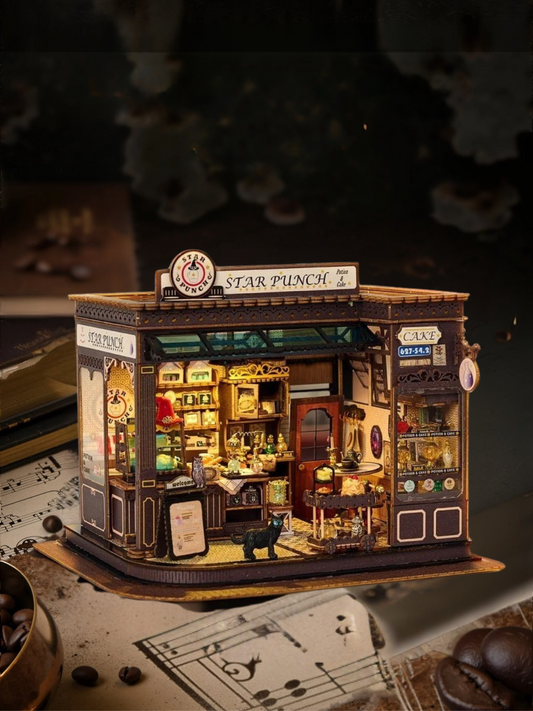 DIY miniature kit featuring “Potion Patisserie,” a whimsical cake and potion shop. Includes magical decor, sweets, golden teapots, and a black cat. Ideal for DIY and crafts lovers, fantasy collectors, and tiny dollhouse hobbyists.