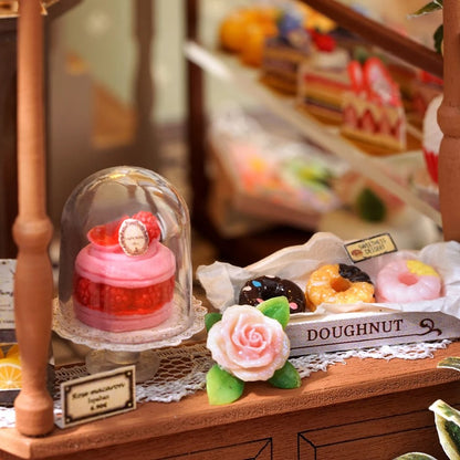 DIY mini house kit “Perch & Latte Loft,” featuring a cozy two-story coffee shop with a glowing café interior, reading nook, lace-curtained loft, and tiny desserts. A warm and detailed build for DIY and crafts lovers and fans of miniature homes.
