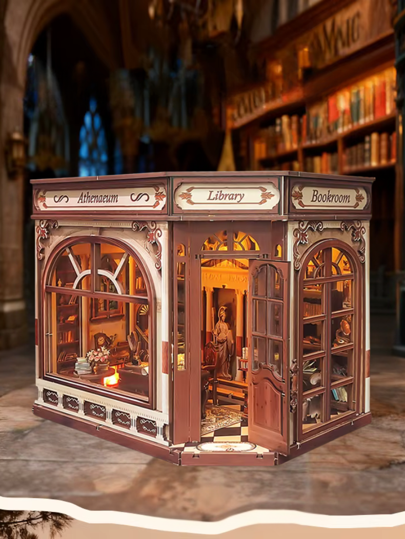 DIY miniature house kit styled as an Athenaeum library with classical columns, bookshelves, and warm lighting in an old-world study.