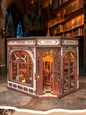DIY miniature house kit styled as an Athenaeum library with classical columns, bookshelves, and warm lighting in an old-world study.