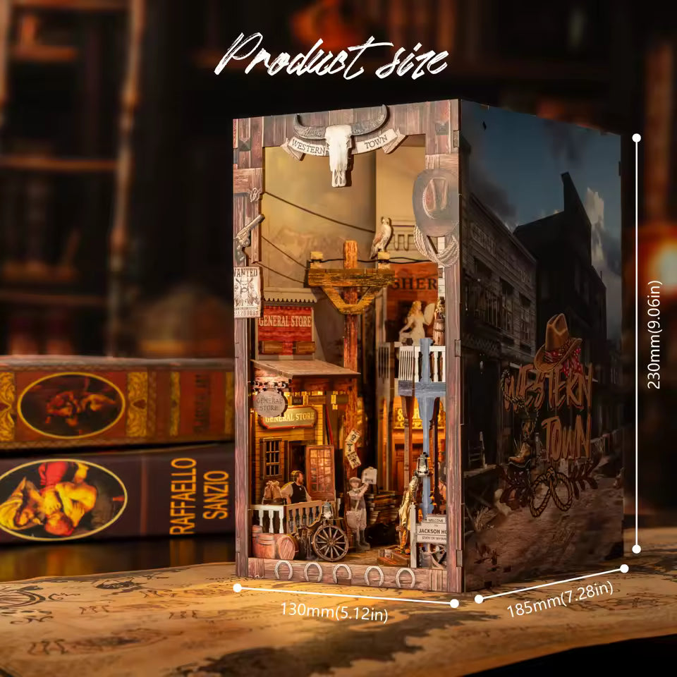 DIY miniature book nook of a Wild West street scene featuring a saloon façade with swinging doors, wooden signage, warm lantern lighting, and rustic storefront details, evoking a classic frontier town at dusk.