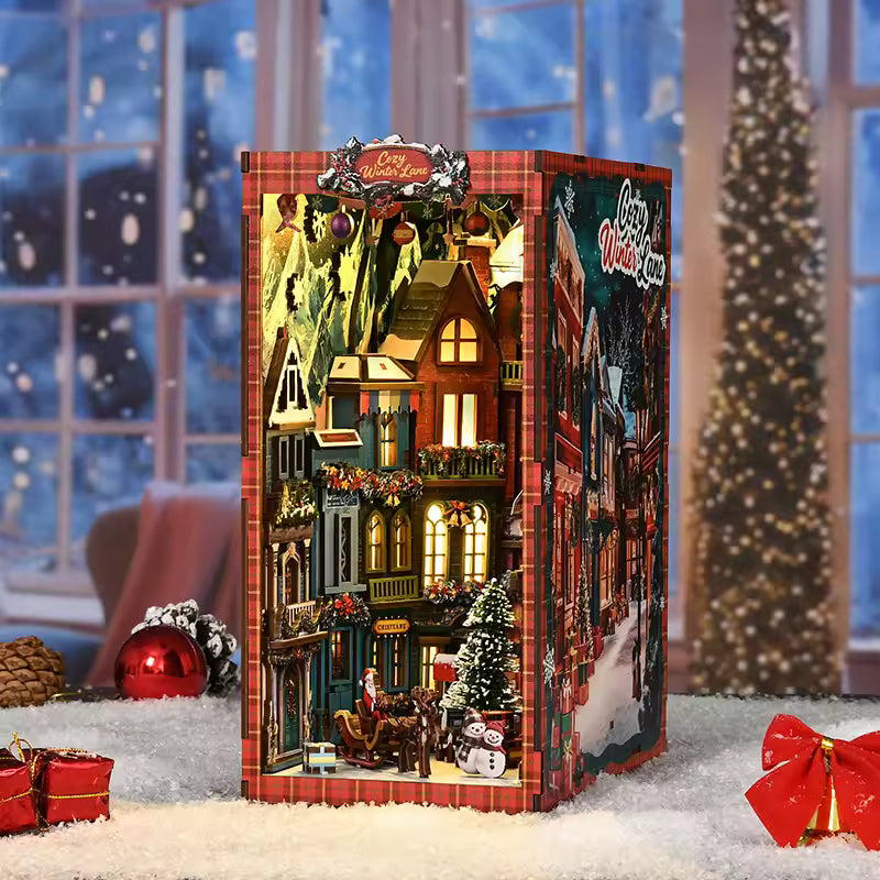 DIY book nook kit “Merry Market Lane,” featuring a warmly lit winter street with festive storefronts, snow-topped rooftops, and a softly bustling holiday vibe. A detailed DIY and crafts project perfect for holiday lovers and miniature collectors.