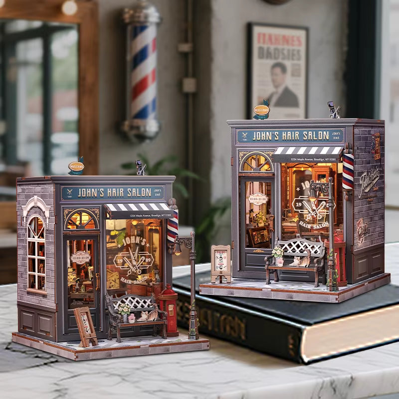 DIY book nook kit “Pomade Parlor,” featuring a vintage barbershop and hair salon interior with red chairs, mirrors, wooden shelves, and miniature grooming tools. A nostalgic DIY and crafts project for fans of retro style, miniatures, and classic salon design.