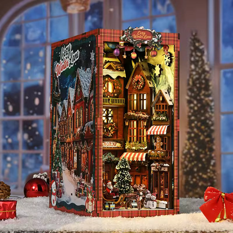 DIY book nook kit “Merry Market Lane,” featuring a warmly lit winter street with festive storefronts, snow-topped rooftops, and a softly bustling holiday vibe. A detailed DIY and crafts project perfect for holiday lovers and miniature collectors.
